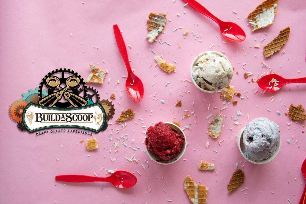 cups of ice cream on a pink background with Build A Scoop's logo