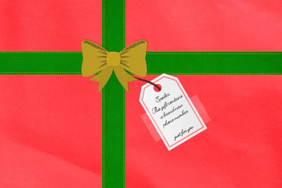 Red wrapping paper with green ribbons, a golden, sparkling bow and a tag taped to it saying, "Spoiler: This gift contains a brand new phone number... just for you."