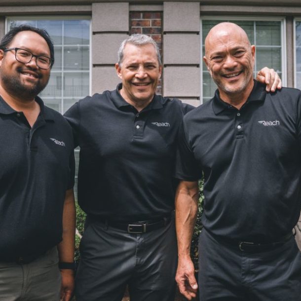 3 team members from Reach Dental Equipment smiling together.